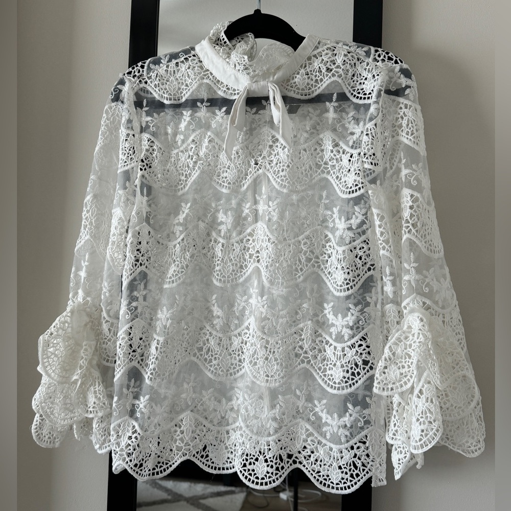 White lace open back top with bow tie and bell sleeves